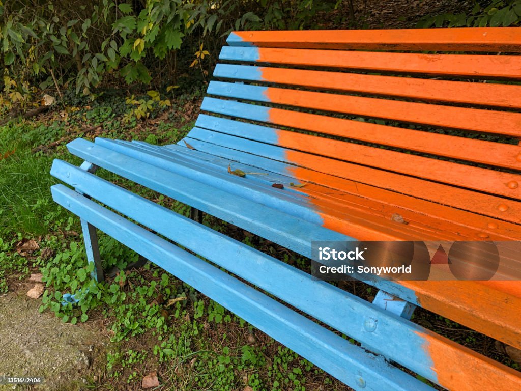 Isolated multi-colored painted park bench Details of artistic painted bench, Paderno Dugnano, Milan Street Art Stock Photo