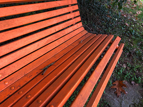 Bench painted with orange, Paderno Dugnano, Milan