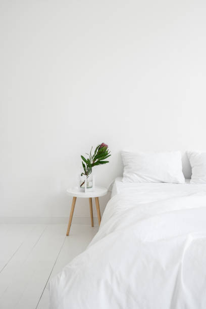 istock Bedroom in white apartment with modern interior design 1351642448