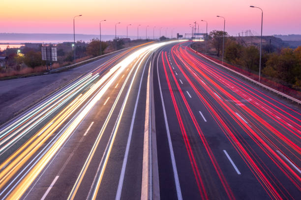 istock Sunset Car Traffic With Trails on a Suburban Highway 1351642538