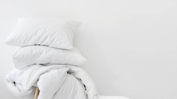 duvet and pillows against white copy space background - pillow imagens e fotografias de stock