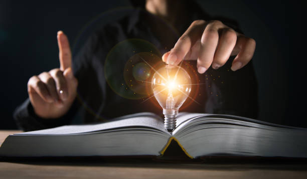 istock woman holding a light bulb of a book 1351644909