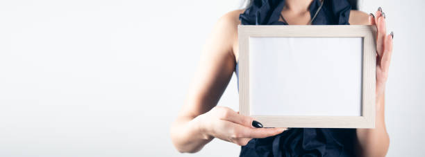istock Woman hand holding photo frame. 1351644947