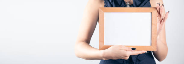 istock Woman hand holding photo frame. 1351644948