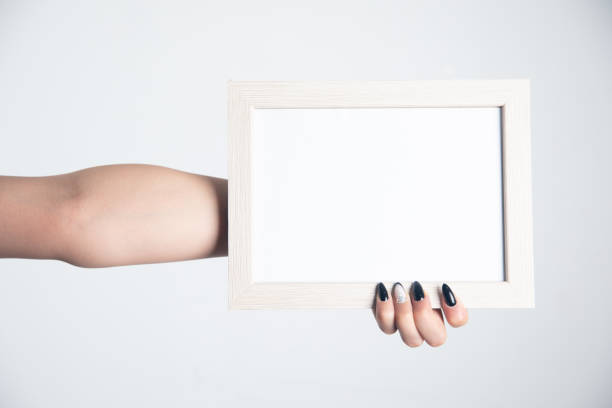 istock Woman hand holding photo frame. 1351644949