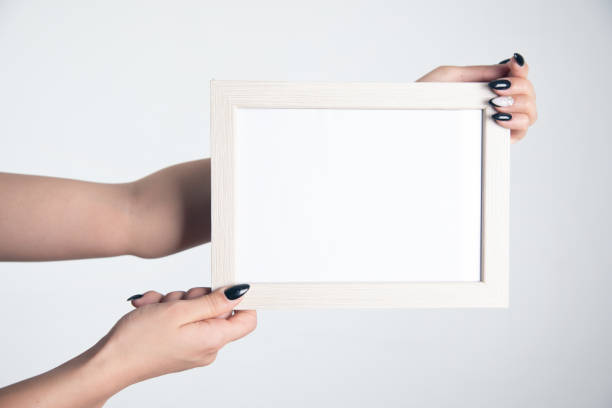 istock Woman hand holding photo frame. 1351644958