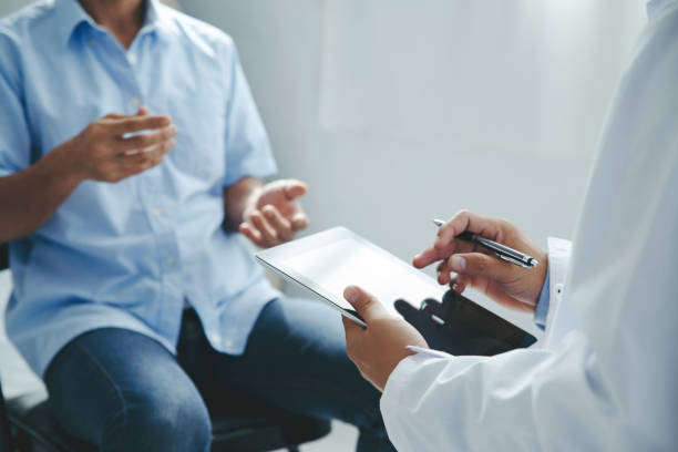 Doctor talking to patients are explaining the treatment of a patient's illness . Health and Medicine concept" stock photo