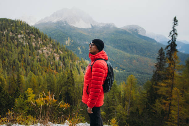 istock Young man backpacker enjoying autumn time in the mountain wilderness 1351647683