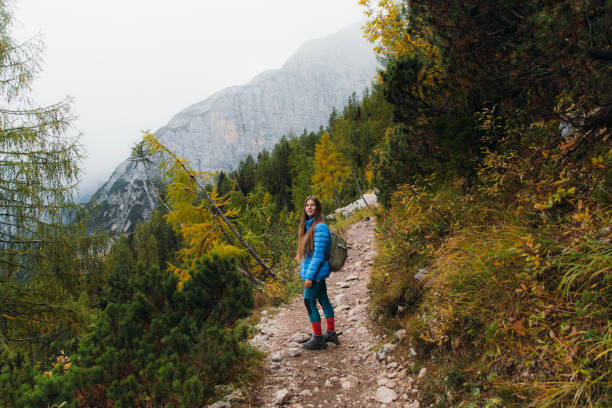 istock Female backpacker enjoying autumn time in the mountain wilderness 1351647698