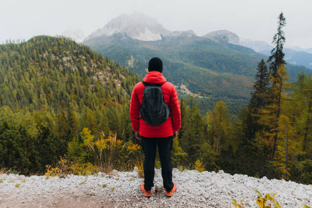 istock Young man backpacker enjoying autumn time in the mountain wilderness 1351647711