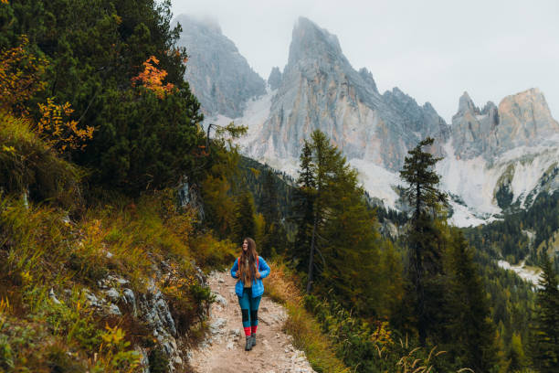 istock Young woman backpacker enjoying autumn time in the mountain wilderness 1351647713