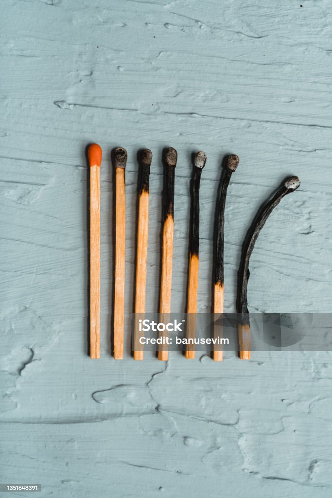 Burnt matchsticks on grey background Burnt Stock Photo