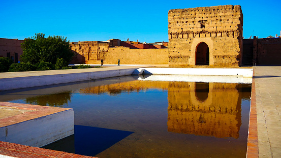 Marrakech, Morocco: Wall's reflection in pool of El Badi Palace or Palais El Badii in Marrakech, Morocco
