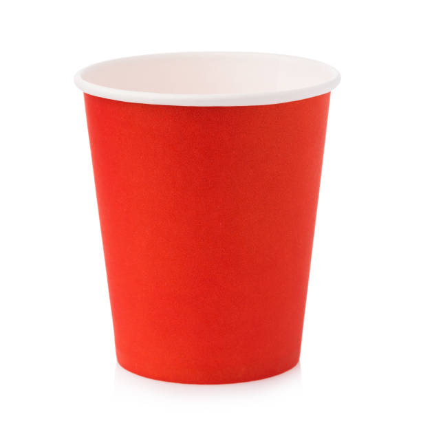 istock Empty paper cup for hot drinks in orange color isolated on white background 1351651071