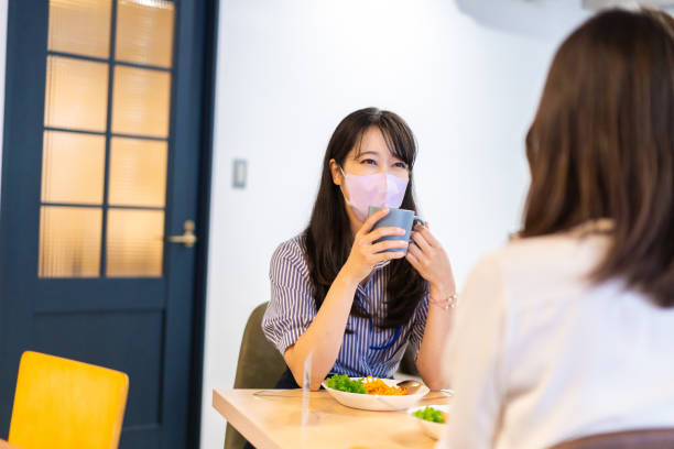 istock Two young women having lunch with mask on 1351651157