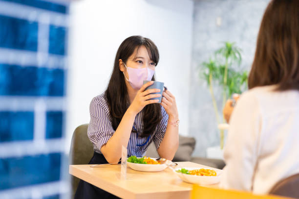 istock Two young women having lunch with mask on 1351651166