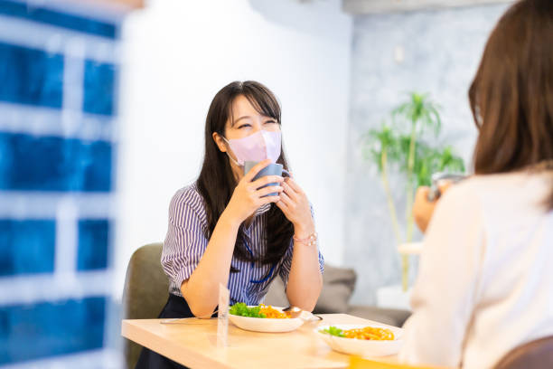 istock Two young women having lunch with mask on 1351651171