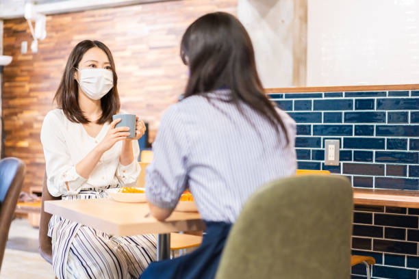 istock Two young women having lunch with mask on 1351651172