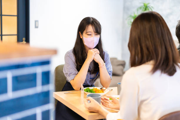 istock Two young women having lunch with mask on 1351651177