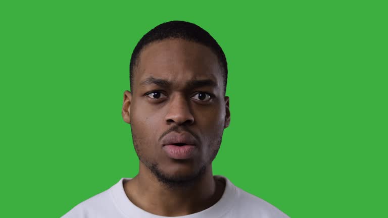 Shocked man over green background