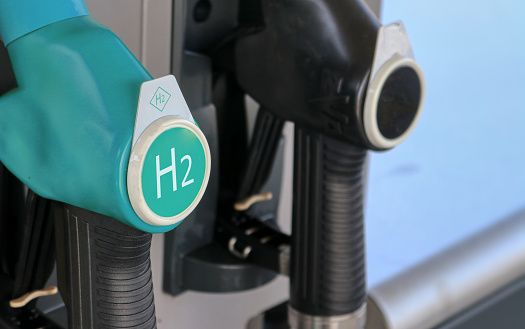 Hydrogen logo on gas stations fuel dispenser. Concept for emission free eco friendly transportation. Green energy. Fuel filler nozzle to fill hydrogen powered vehicles