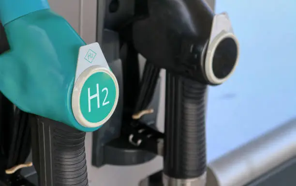 Photo of Hydrogen logo on gas stations fuel dispenser. Concept for emission free eco friendly transportation. Green energy. Fuel filler nozzle to fill hydrogen powered vehicles