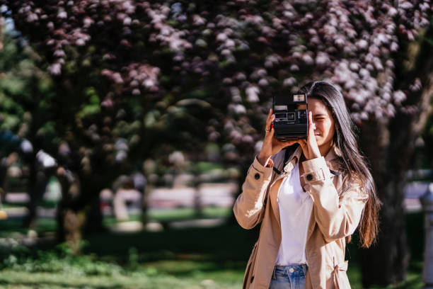 istock A GIRL WITH A CAMERA TAKING PHOTOS 1351652331