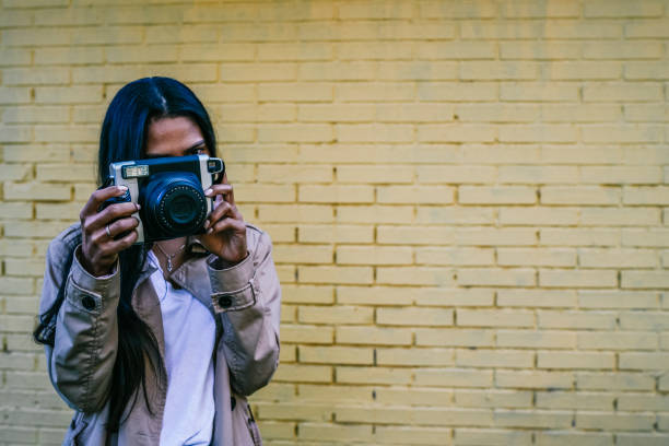 istock A GIRL WITH A CAMERA TAKING PHOTOS 1351652340