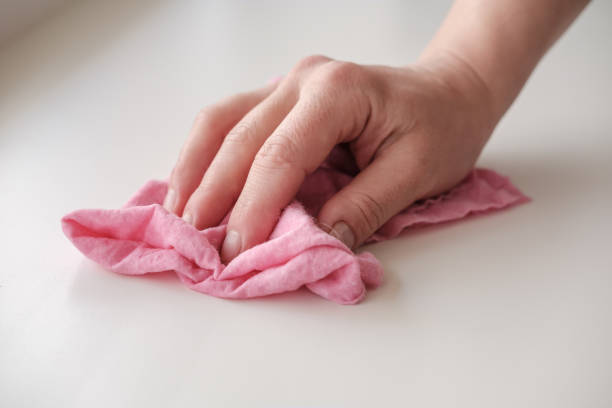 istock Female hand with a rag rubs a white table. Concept of cleanliness. Housework. 1351657493