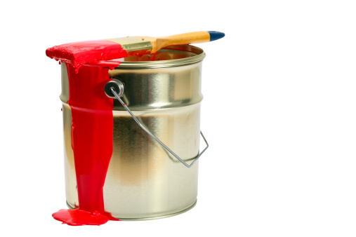 An open paint can with red paint.Clipping path.