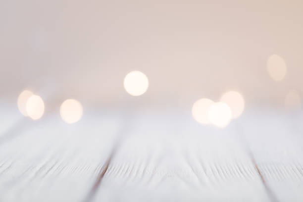 istock white abstract bokeh background behind wooden desk 1351658791