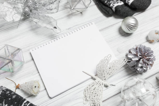 istock silver christmas decorations and notebook on white background. Flat lay, top view, copy space 1351660044