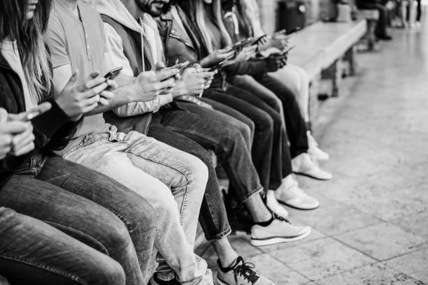 Young happy people using mobile phones outdoor
