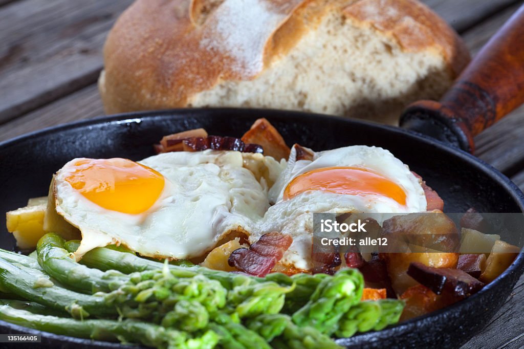 Lunch A classic pan with delicious fried eggs in it. Asparagus Stock Photo