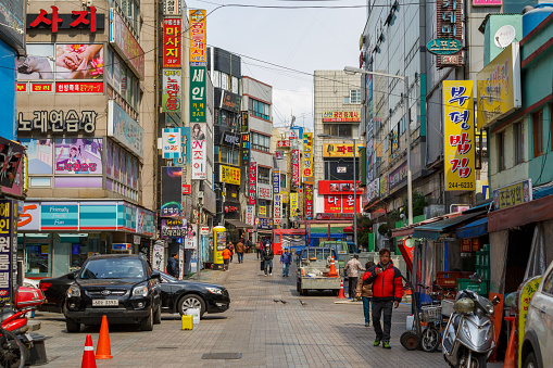 Busan, South Korea - March 25, 2016: Street with trading advertising signboards.