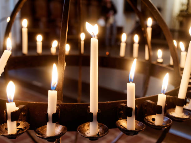 istock Closeup Burning candles on stand in church 1351665922