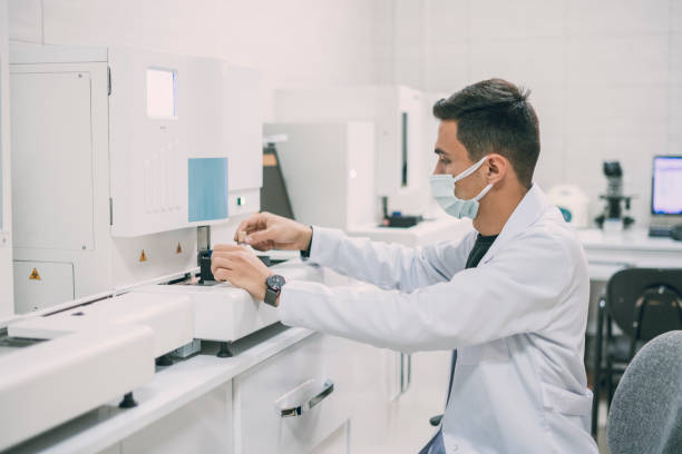 istock Scientist working in laboratory.He is typing the screen of biochemistry machine 1351668702