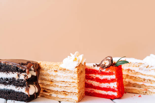 istock Four pieces of different cakes on beige background 1351670869