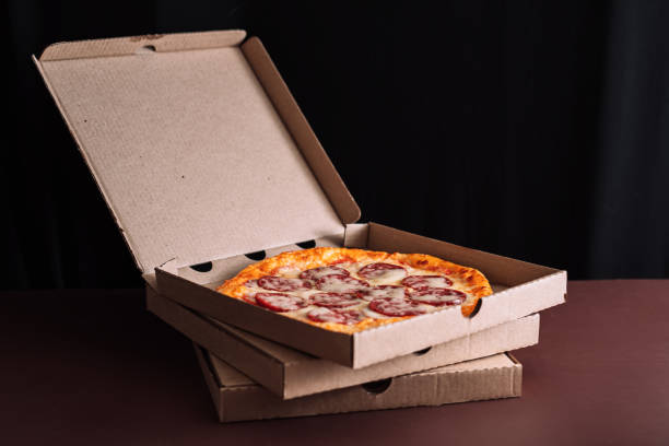 istock An open box of pizza standing on top of other boxes 1351670873