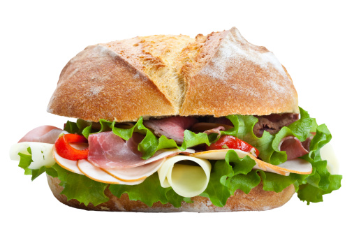 Big sandwich with roast beef, prosciutto, cheese and vegetables.