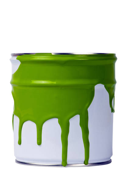 istock White paint can with green paint spilling out the top 135167367