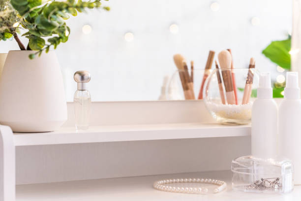 istock Table mirror on dressing table with make up accessories. Self-Care. White, pastel interior 1351676612