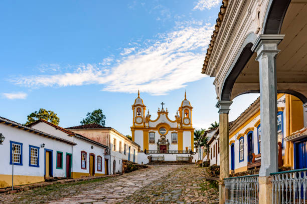 A quiet historic street in the city of Tiradentes in Minas Gerais A quiet historic street in the city of Tiradentes in Minas Gerais with colonial houses and a baroque church in the background minas gerais state stock pictures, royalty-free photos & images