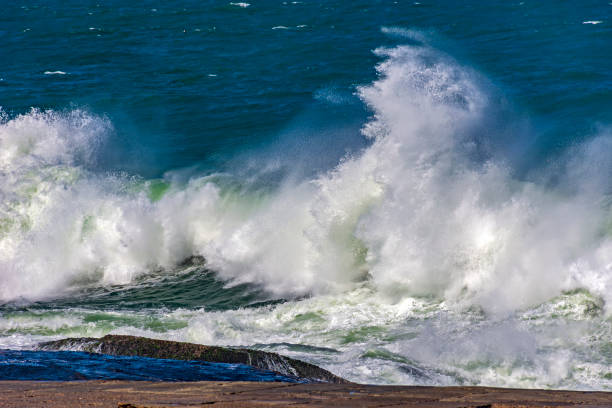 Photo of Strong waves crashing against rocks
