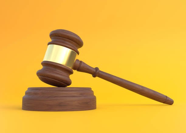 istock Wood Judge gavel on yellow background 1351681366