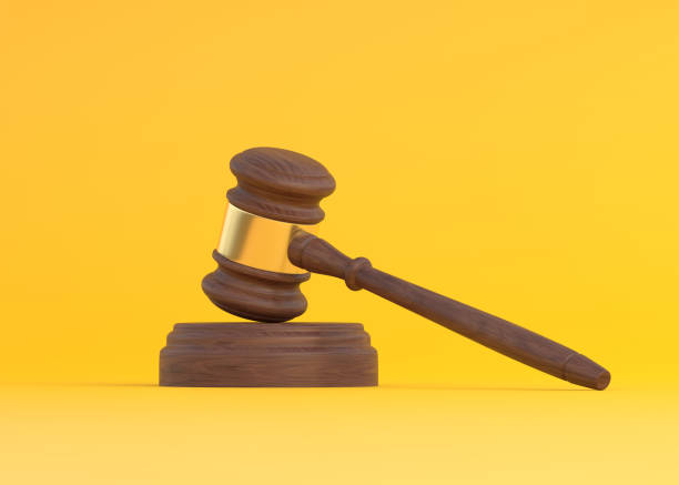 istock Wood Judge gavel on yellow background 1351681369