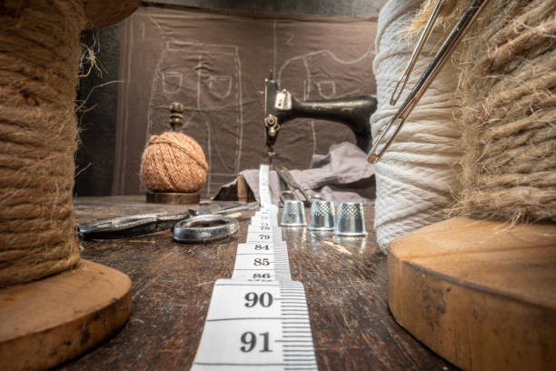 istock Traditional tailor workshop with tape measure and threads on spools. 1351683891