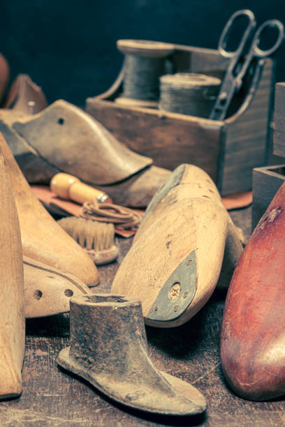 istock Antique shoemaker workshop with with tools, anvil, shoes and rule. 1351683980