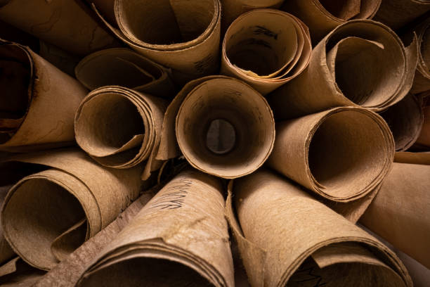 Scrolls with futhpak symbols stacked on pile. Ancient scribe library. stock photo