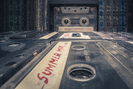 Closeup of vintage cassette and player. Tapes and player with spinning audio cassette.